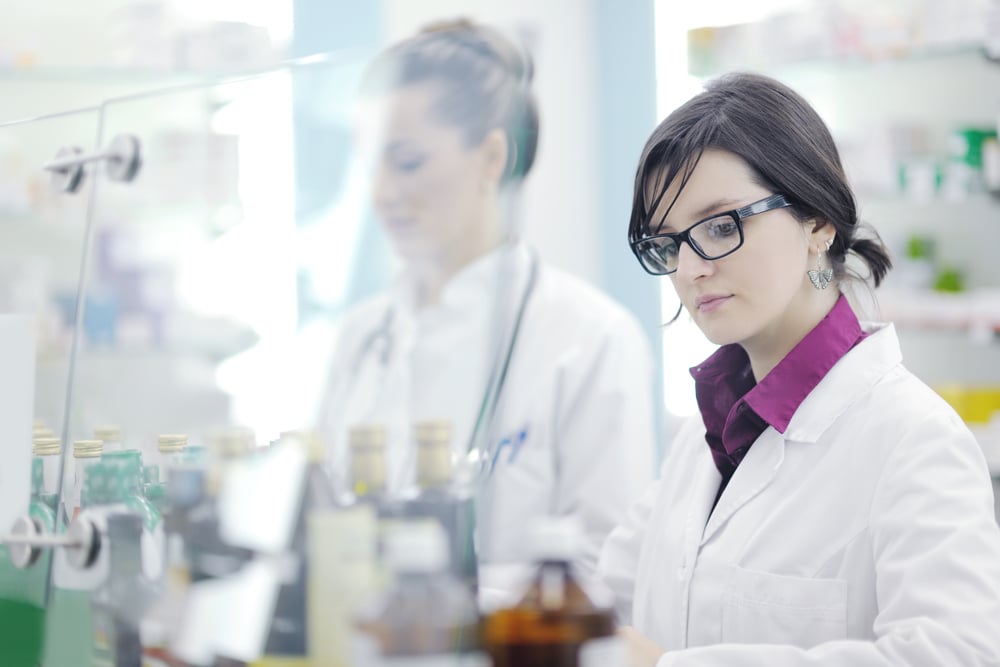 team of  pharmacist chemist woman group  standing in pharmacy drugstore