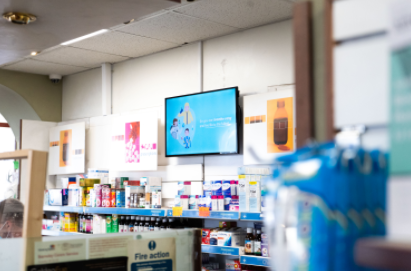 digital display screen in pharmacy above medications